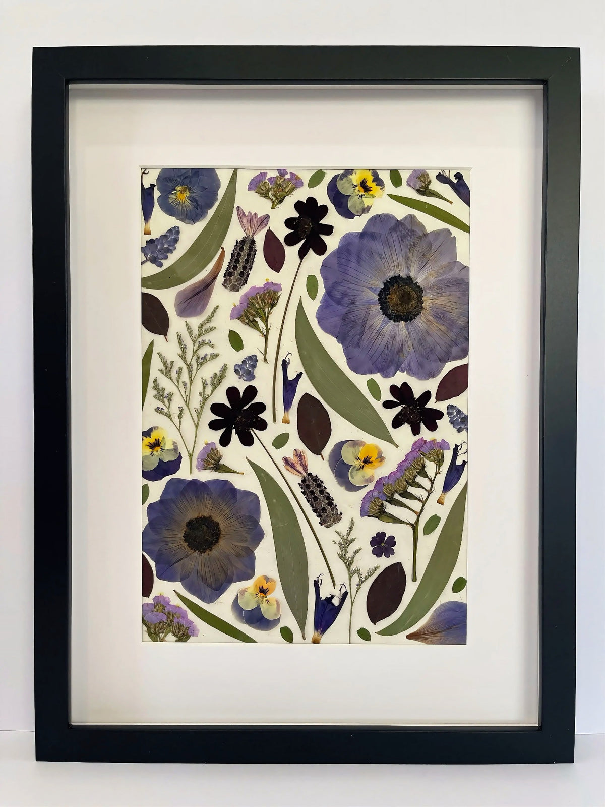 Dusk pressed flower artwork in a black frame