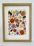 Nectar pressed flower artwork in a light oak frame