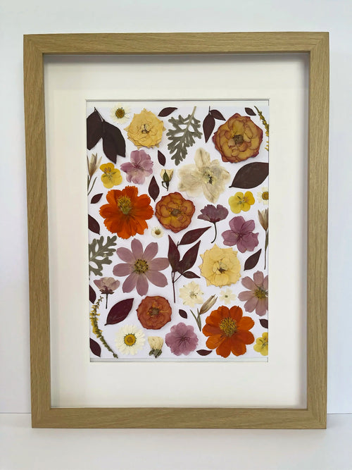 Nectar pressed flower artwork in a light oak frame