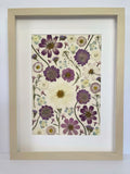 Stardust pressed flower artwork in a light frame